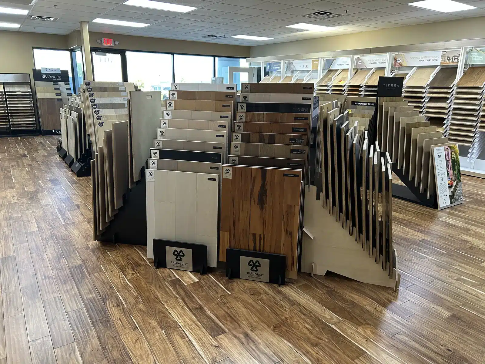 Wood flooring plank samples arranged in multiple showroom display racks